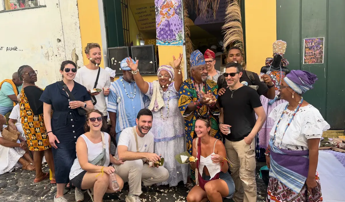 Travelers celebrating with baianas in traditional dress